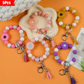 A 5pcs Collection Featuring a Daisy Flower Silicone Keychain And Printed Wooden Beads, Ideal for Holiday Gifting