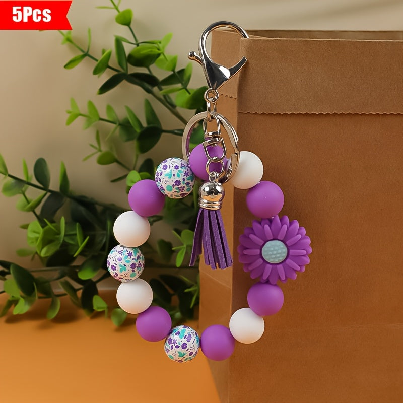 A 5pcs Collection Featuring a Daisy Flower Silicone Keychain And Printed Wooden Beads, Ideal for Holiday Gifting